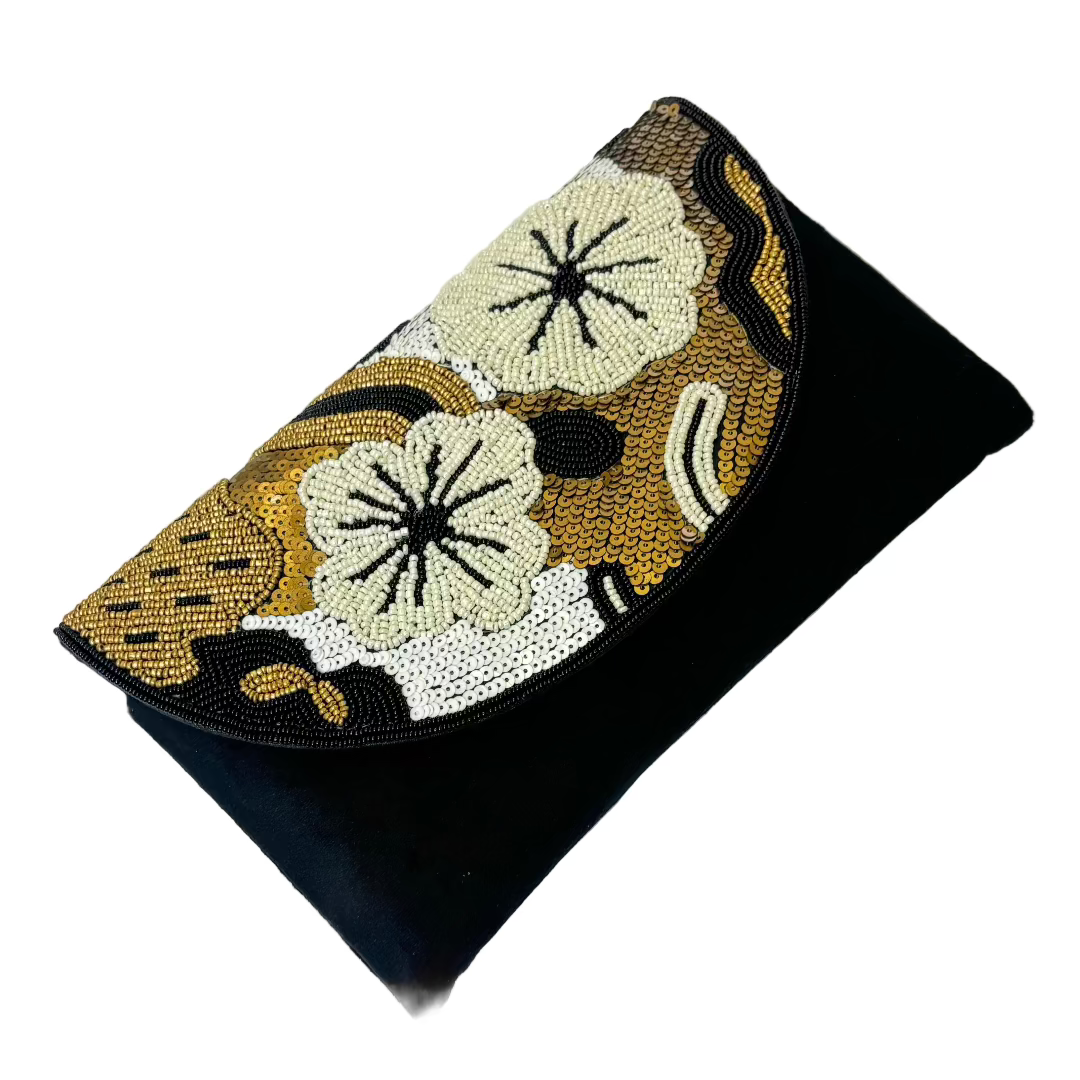 A black velvet clutch with intricate floral embroidery and a sequin design, displayed on a white surface.